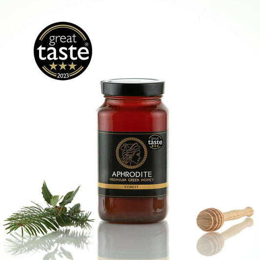 Greek Raw Forest Honey in a 950g glass jar in white background. Jar presented from the front . 100% Pure Honey. Aphrodite Honey. Aphrodite Premium Greek Honey.