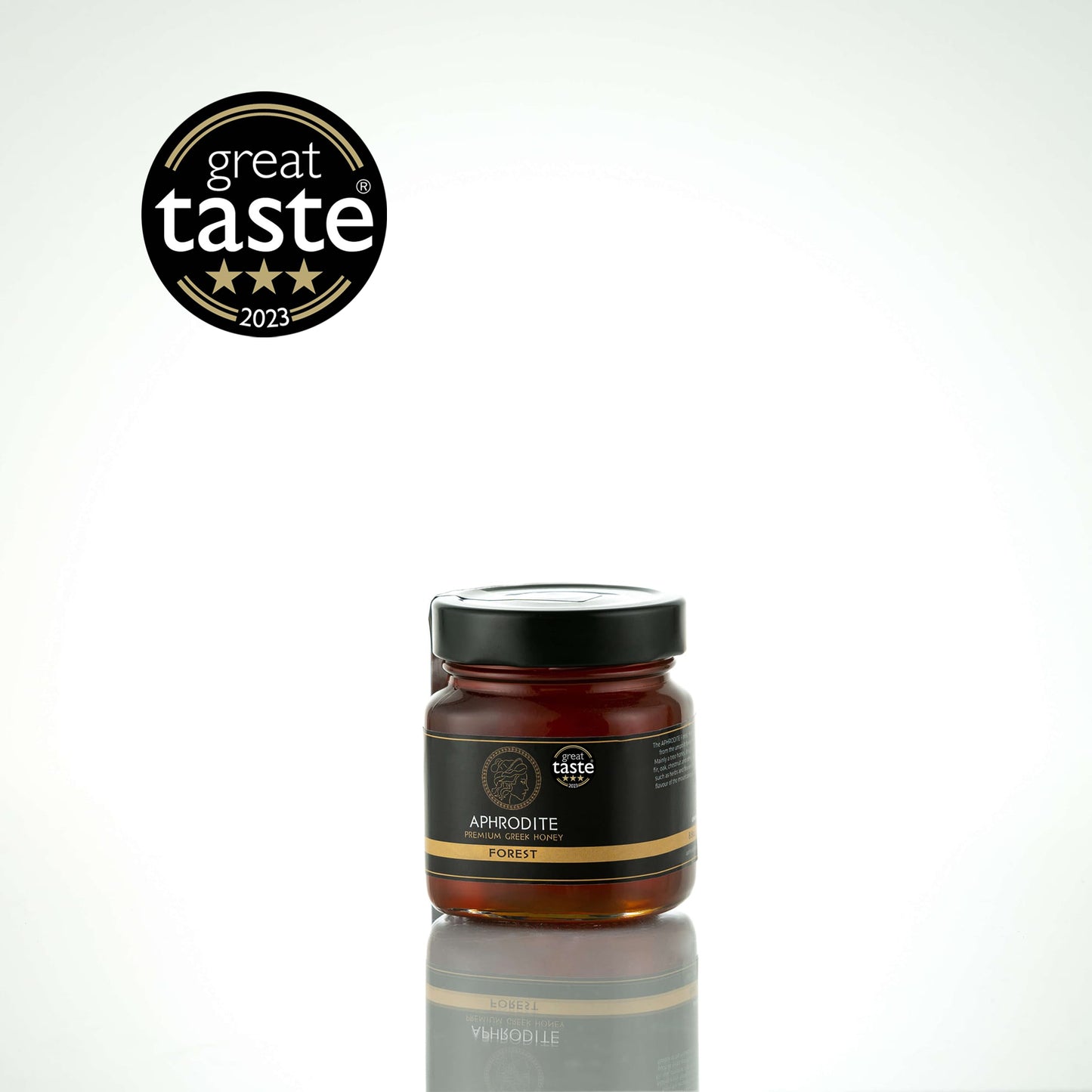 Greek Raw Forest Honey in a 250g glass jar in white background. Jar presented on the side. 100% Pure Honey. Aphrodite Honey. Aphrodite Premium Greek Honey.