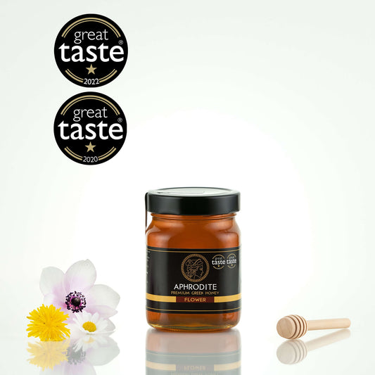Greek Raw Flower / Blossom Honey in a 500g glass jar in white background. Jar presented from the front . 100% Pure Honey. Aphrodite Honey. Aphrodite Premium Greek Honey. Great Taste 1 star.