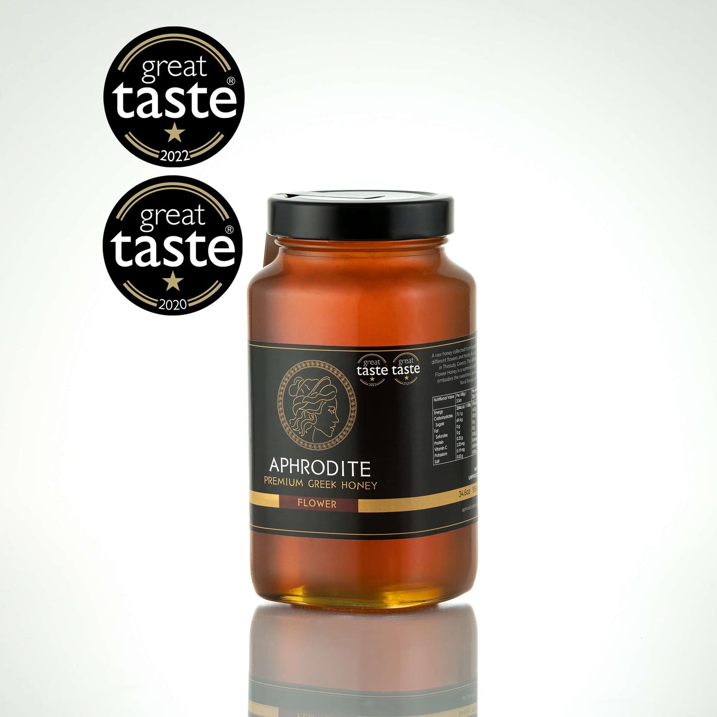 Greek Raw Flower / Blossom Honey in a 950g glass jar in white background. Jar presented on the side. 100% Pure Honey. Aphrodite Honey. Aphrodite Premium Greek Honey. Great Taste 1 star.