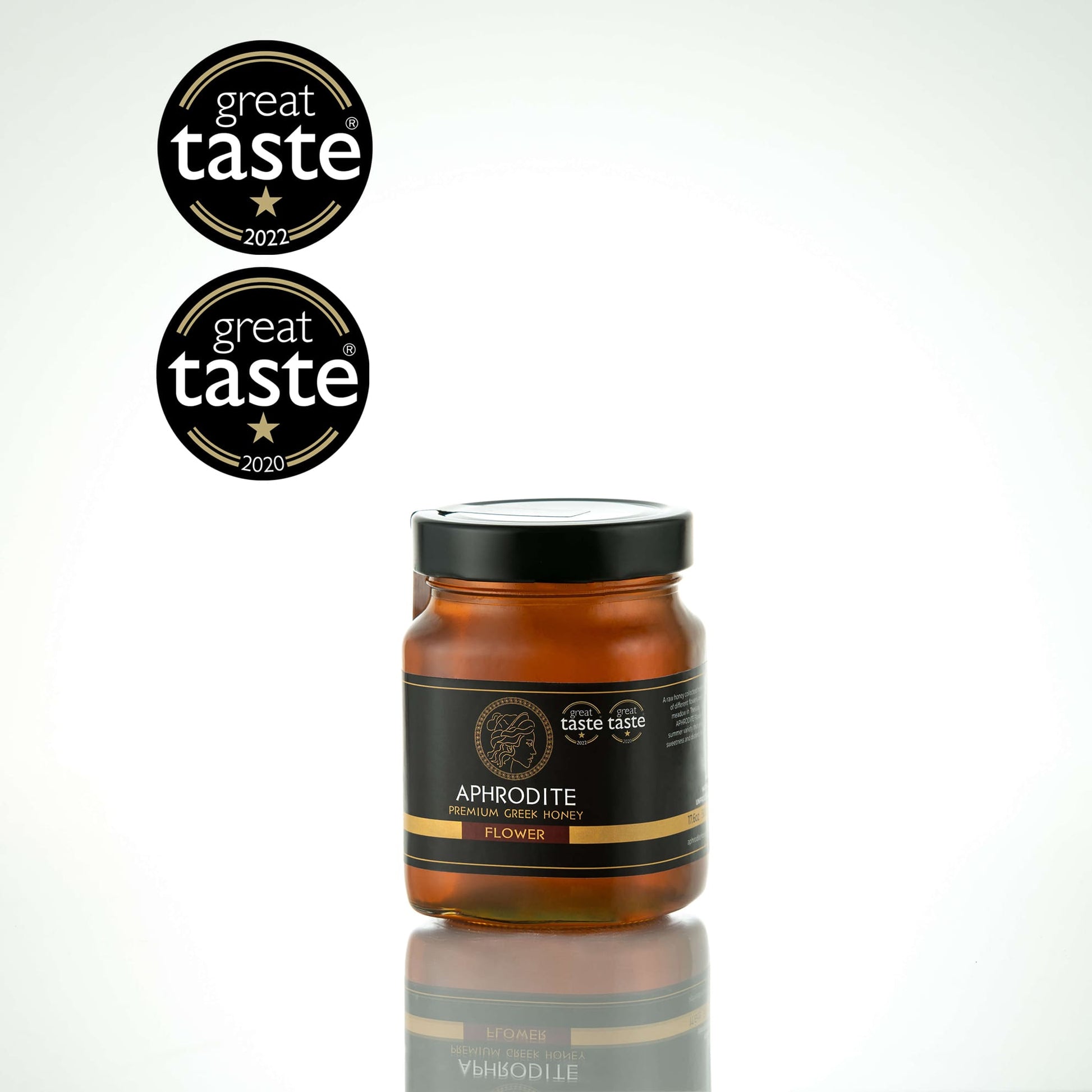 Greek Raw Flower / Blossom Honey in a 500g glass jar in white background. Jar presented on the side. 100% Pure Honey. Aphrodite Honey. Aphrodite Premium Greek Honey. Great Taste 1 star.