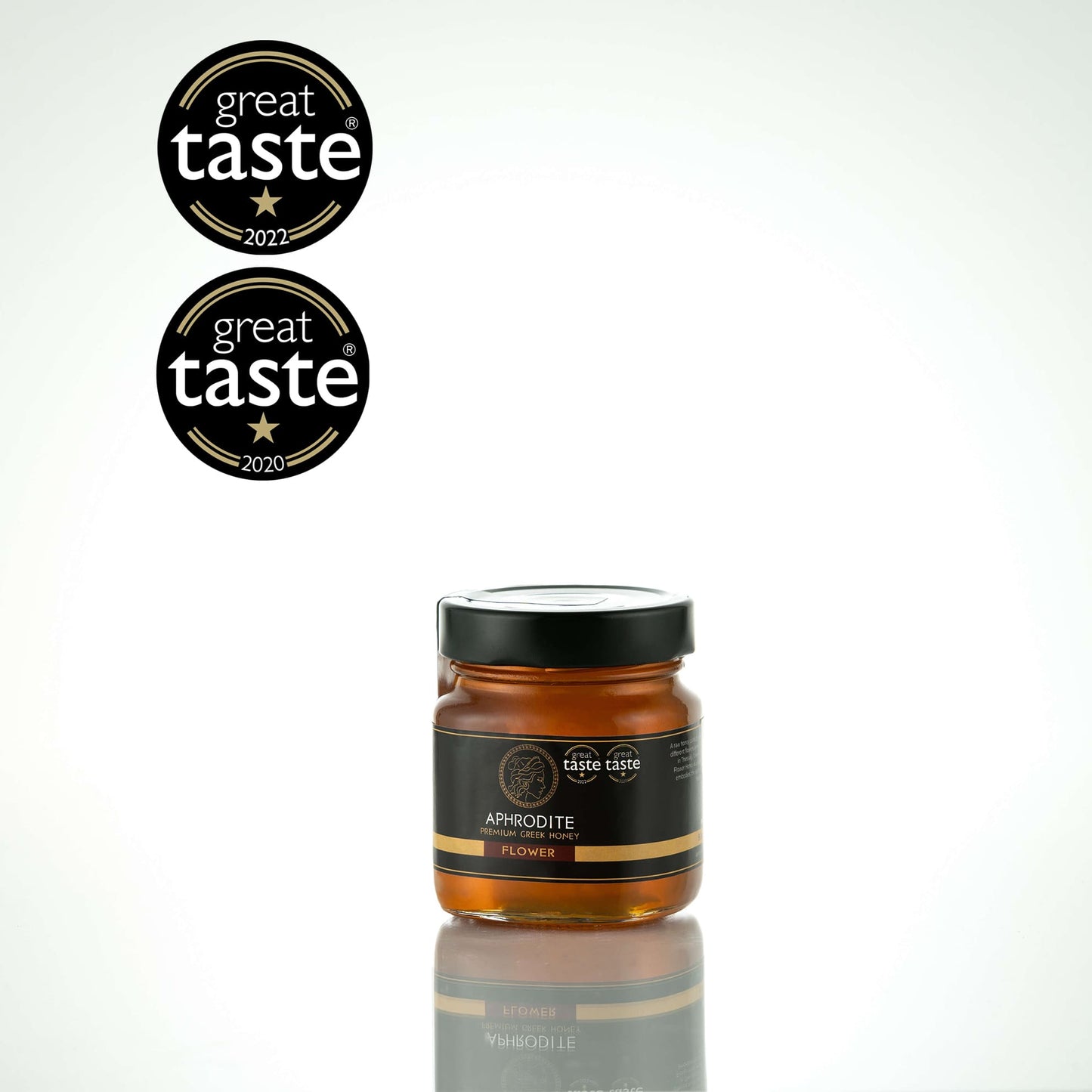 Greek Raw Flower / Blossom Honey in a 250g glass jar in white background. Jar presented on the side. 100% Pure Honey. Aphrodite Honey. Aphrodite Premium Greek Honey. Great Taste 1 star.