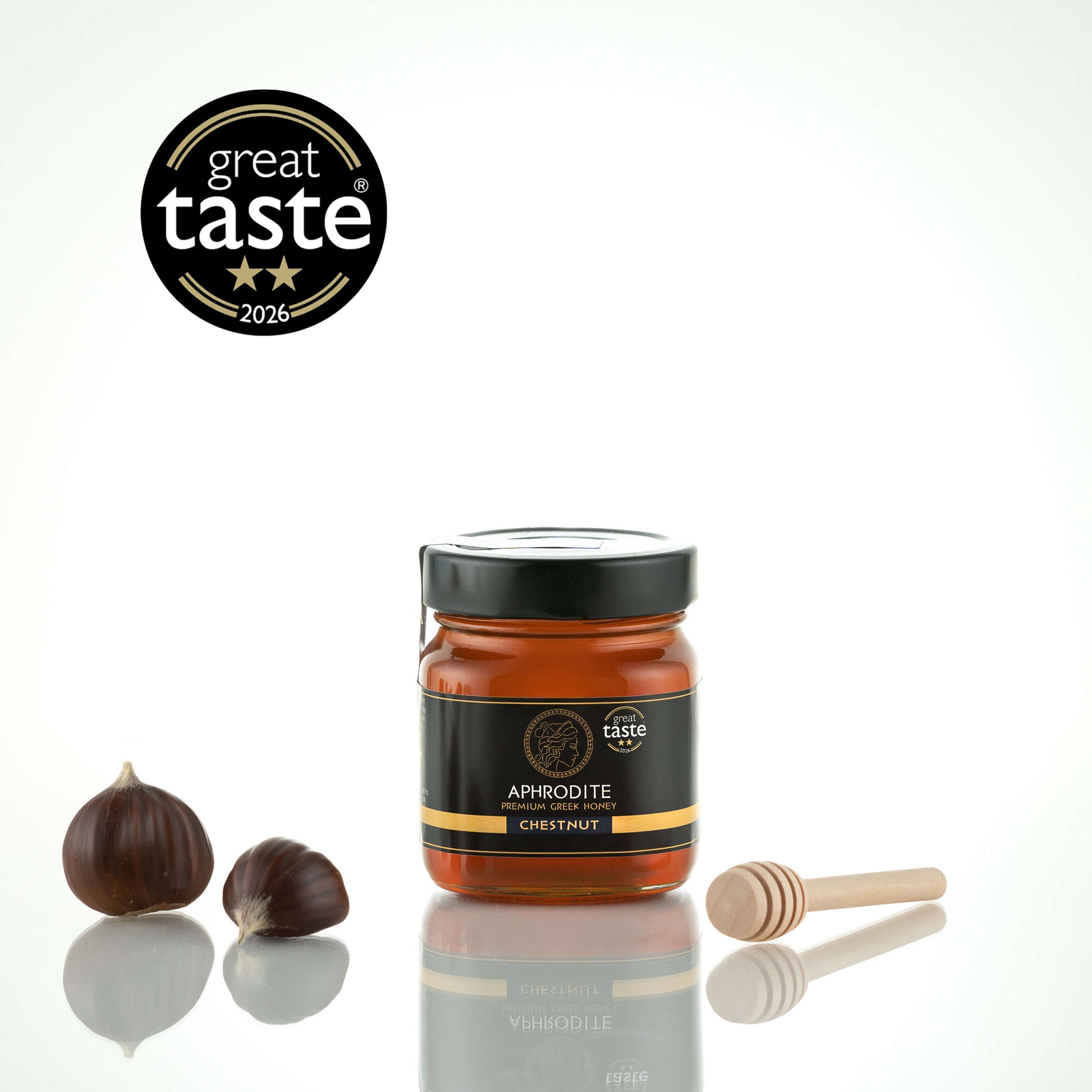 Aphrodite Raw Chestnut Honey 250g jar with whole chestnuts and wooden honey dipper, 2026 Great Taste award badge
