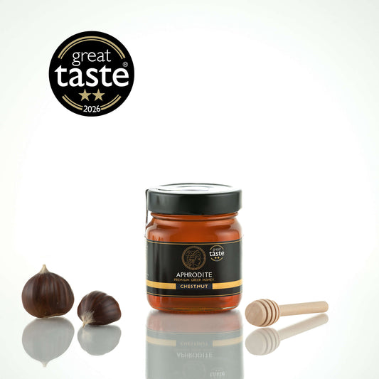 Aphrodite Raw Chestnut Honey 250g jar with whole chestnuts and wooden honey dipper, 2026 Great Taste award badge