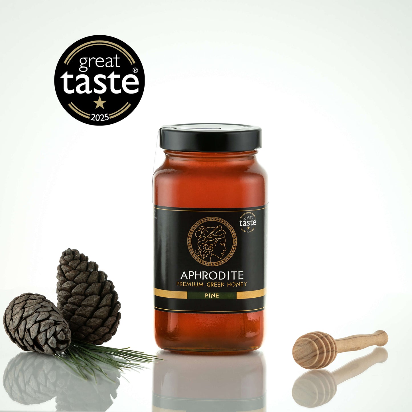 Aphrodite Raw Pine Honey 950g large jar with pinecones, a pine sprig and honey dipper, Great Taste 2025 award badge, white background