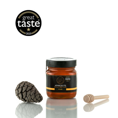 Aphrodite Raw Pine Honey 250g jar with a pinecone and honey dipper, Great Taste 2025 award badge, white background