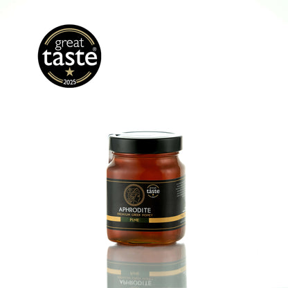 Aphrodite Raw Pine Honey 480g glass jar with black lid on a white reflective background, Great Taste 2025 award badge