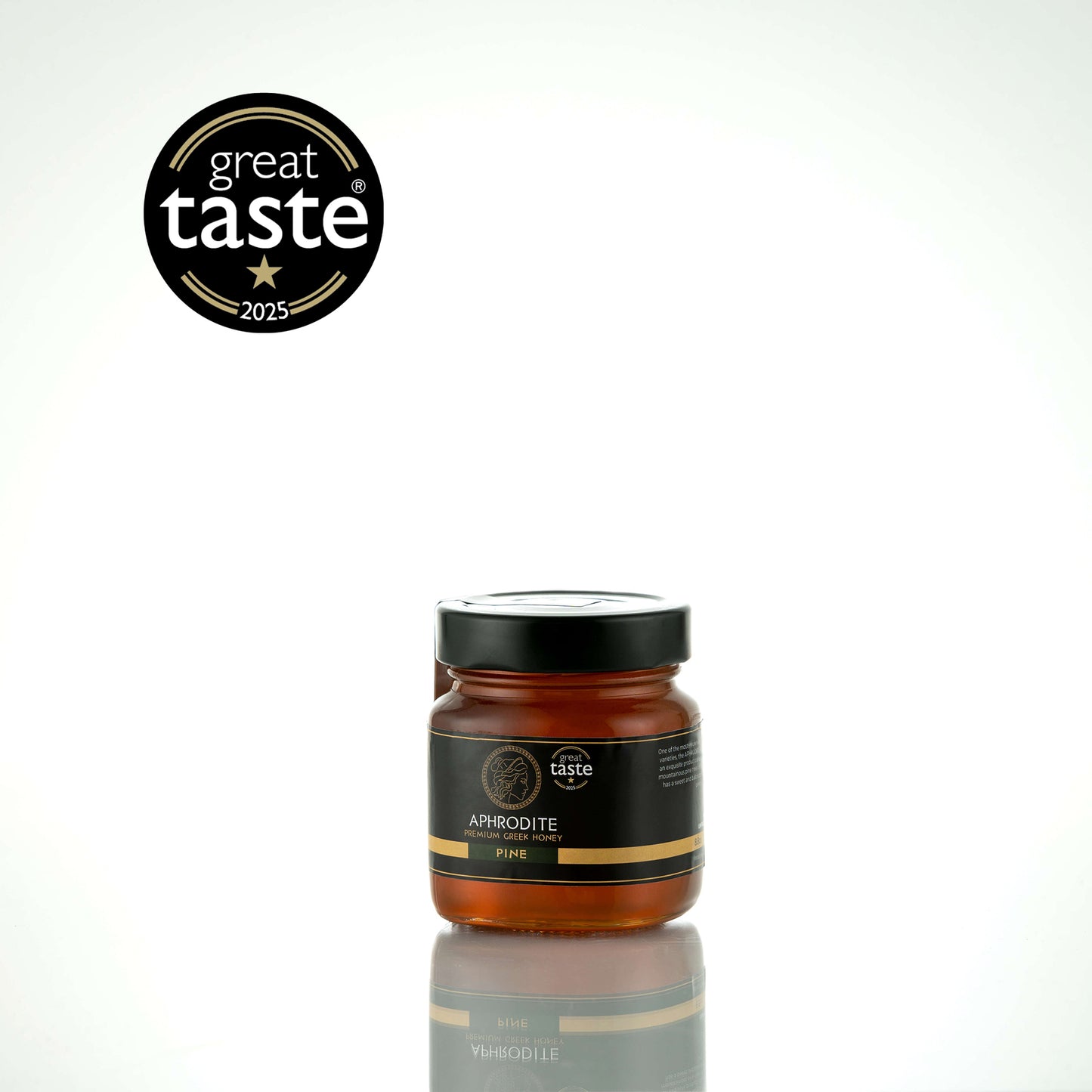 Aphrodite Raw Pine Honey 250g glass jar with black lid on a white reflective background, Great Taste 2025 award badge
