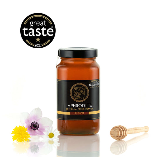 Aphrodite Raw Flower Honey 950g jar with wildflowers and a honey dipper, Great Taste 2022 award badge, white background