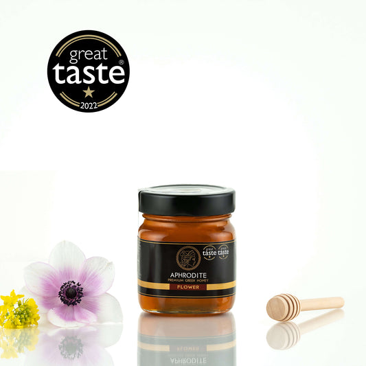 Aphrodite Raw Flower Honey 250g jar with wild anemone flowers and a honey dipper, Great Taste 2022 award badge, white background